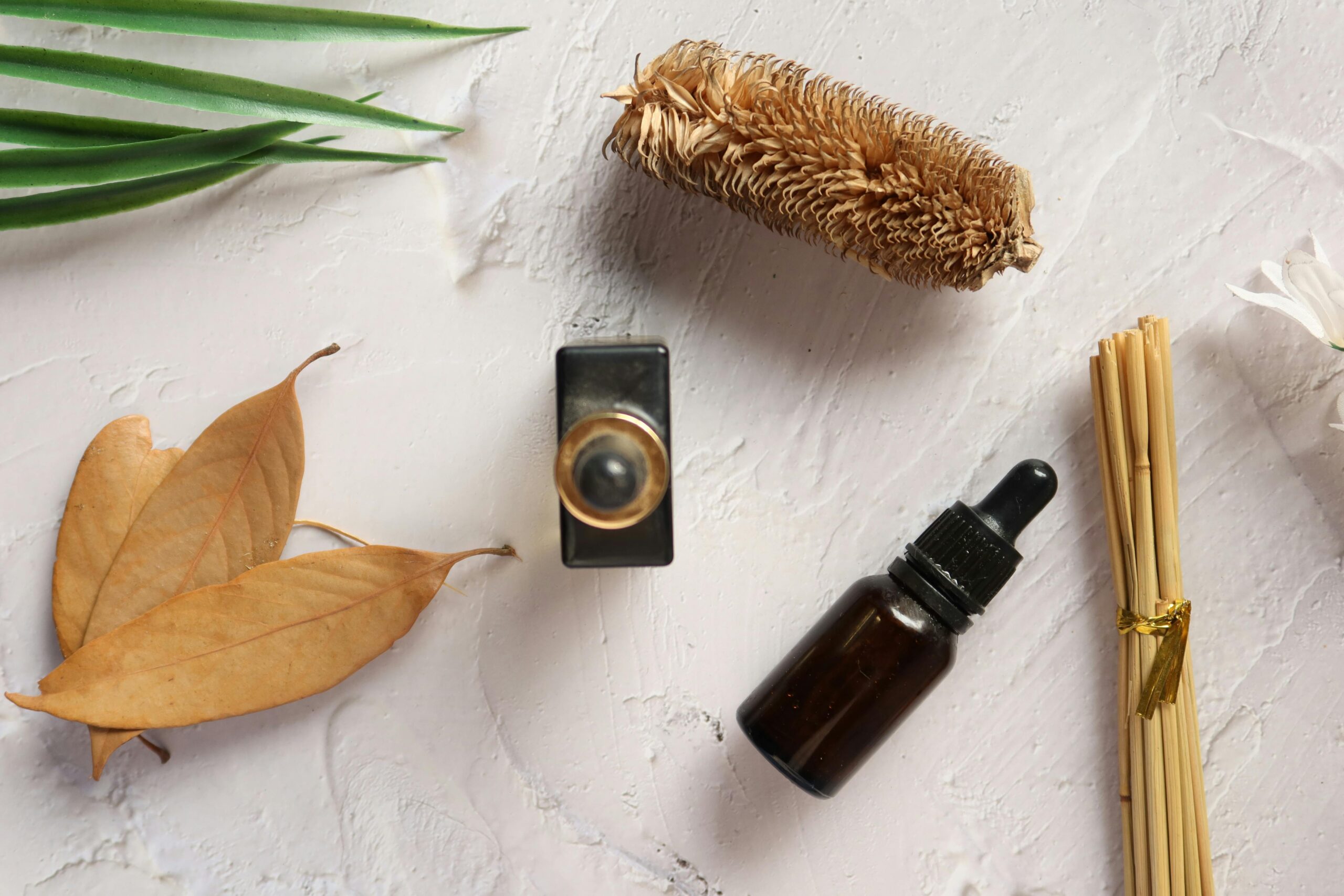 pexels photo 14624607 14624607 Flat lay of aromatherapy oils and natural elements on a textured surface. Perfect for wellness themes.